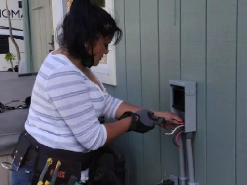 Licensed electrician wiring an exterior subpanel in Greenville